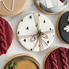 decorated cookies and pastries are arranged on a table