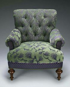 an upholstered chair with purple and green fabric