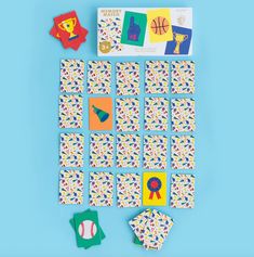 an assortment of colorful cards and magnets on a blue background