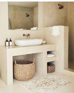 a bathroom with a sink, mirror and shower stall