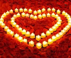 many candles are arranged in the shape of a heart