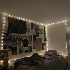 a bedroom with string lights and pictures on the wall