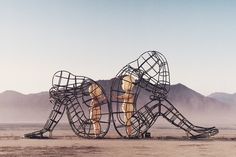 a large metal sculpture in the middle of a desert