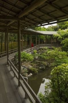 the walkway is lined with trees and rocks, along with a small pond in the middle