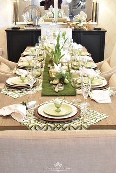 a dining room table set with place settings