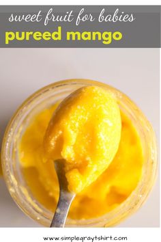 a spoon full of mango puree with the text sweet fruit for babies, pureed mango