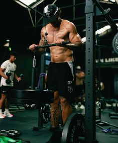 a shirtless man working out in the gym