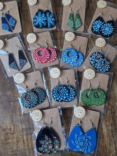 several pairs of beaded earrings are on display in their packagings, with price tags attached to them