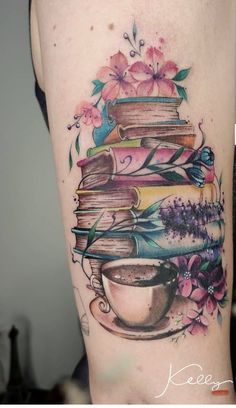 a woman's thigh with books and a coffee cup on it, all covered in flowers