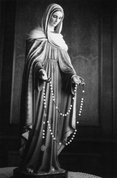 a statue of the virgin mary in black and white