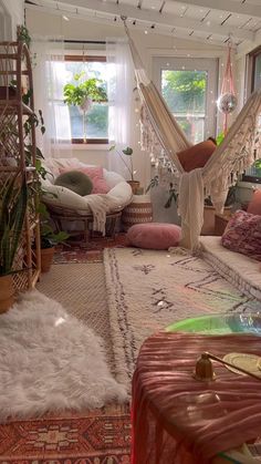 an image of a living room with hammock hanging from the ceiling and rugs on the floor