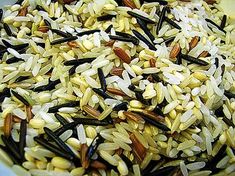 a bowl filled with rice and nuts on top of a table