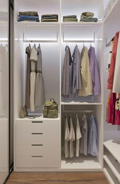 an organized closet with clothes and handbags