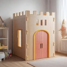 a child's room with a wooden castle bed and play house in the corner