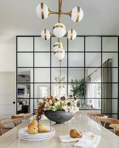 a dining room table with plates and bowls on it