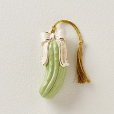 an ornament shaped like a banana hanging on a wall