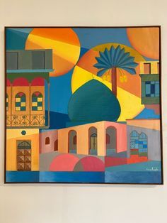 a painting hanging on the wall in front of a white wall with an orange and blue dome