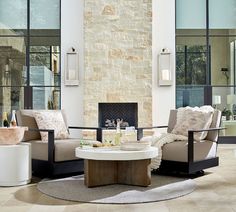 a living room with two couches and a coffee table in front of a fireplace