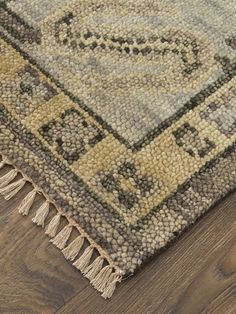 an area rug on the floor with wooden floors and wood planks in the background