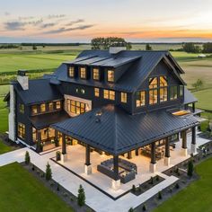 an aerial view of a large house at sunset