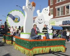 a man sitting on the back of a float in a parade