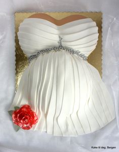 a cake that looks like a dress with a flower on the front and back side