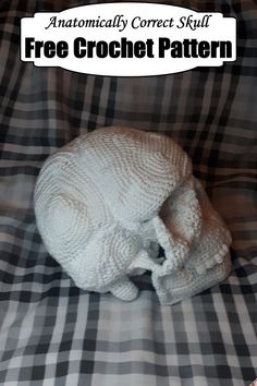 an animal made out of knitted material sitting on top of a plaid blanket with the caption free crochet pattern