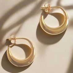 These solid earrings are immensely sleek and of a timelessly attractive form, and are based on examples from ancient Cyprus. Known as "boat" earrings, they feature a gently swollen crescent shape, and a post back. "Tullia" is the female patronymic of the family name Tullius. One famous Tullia was the beloved daughter of Marcus Tullius Cicero (106 - 43 BC), famous orator and statesman of the Late Republic. Cicero had only one daughter, and he was completely devoted to her. When she sadly predecea Minimalist Rounded Jewelry With Shiny Finish, Modern Semi-circle Earrings For Everyday, Elegant Sterling Silver Rounded Earrings, Elegant Rounded Sterling Silver Earrings, Modern Crescent Hoop Earrings For Everyday, Elegant Rounded Tarnish Resistant Earrings, Contemporary Round Earrings, Contemporary Round Earrings For Everyday, Elegant Rounded Tarnish-resistant Jewelry