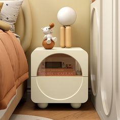 a white nightstand with a teddy bear on top