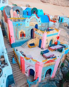 an aerial view of a colorfully painted building with steps leading up to the top