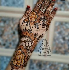 a woman's hand with henna on it and flowers painted on the palm