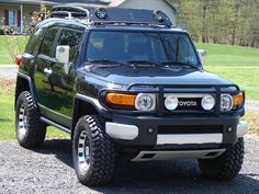 a black toyota truck parked in front of a house