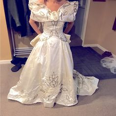 a woman in a white wedding dress standing next to a closet