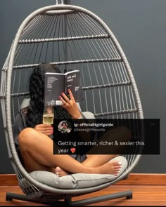 a woman sitting in a chair reading a book