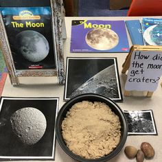 a table topped with pictures and books about the moon