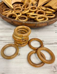 several wooden rings sitting on top of a table next to a basket filled with books