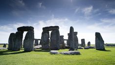 the stonehenge monument stands in an open field