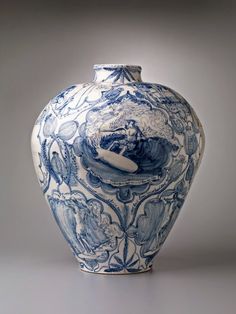 a blue and white vase sitting on top of a table