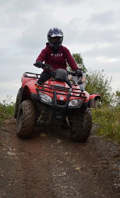 a person riding an atv on a dirt road