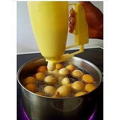 a person pouring juice into a pot filled with potatoes