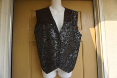 Vintage sparkly vest with three front snap closures and adjustable tie in the back. Labeled size Large, please see measurements. In good vintage condition!!21" armpit to armpit across front lying flat -doubles to 42" around20" across waist23" length Vintage Party Vest For Summer, Vintage Summer Party Vest, Fitted Vest For Night Out In Fall, Vintage Fitted Party Vest, Winter Party Fitted Vest, Glamorous Fitted Vest For Spring, Vintage Black Party Vest, Vintage Black Vest For Party, Vintage Party Vest For Spring