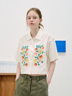 The bohemian shirt featuring the flower embroideries. The cropped length makes the legs look longer, and the loose silhouette fits various sizes comfortably. The shell buttons also elevated the quality. - Loose silhouette and cropped length- Colorful flower embroideries at front- Shell buttons closure at front- Comfortable and lightweight cotton made Casual Embroidered Cropped Blouse, Casual Cropped Embroidered Blouse, Summer Floral Embroidered Relaxed Fit Shirt, Summer Floral Embroidery Relaxed Fit Shirt, White Cropped Shirt Relaxed Fit For Spring, Summer Embroidered Cropped Blouse, Spring Floral Embroidery Relaxed Fit Shirt, White Relaxed Fit Cropped Shirt For Summer, Cropped Floral Embroidered Blouse