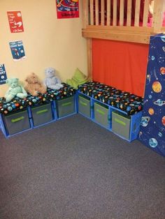 there are many toy bins in the room with space themed decorations on the walls