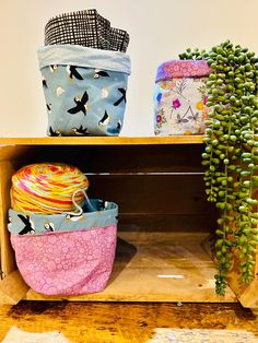 three baskets are stacked on top of each other and one has a plant in it