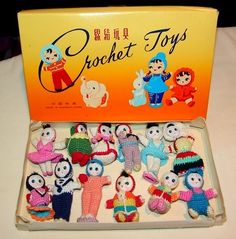 there are many crochet toys in the box on the table with it's lid open