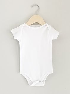 FEATURES: Super soft hand feel, 100% certified organic cotton, made in USA ITEM DETAILS:Set on neck trimNeck tape shoulder to shoulderDouble needle sleeve and bottom hem SIZE CHART:0-3M (onesie)- chest 10"-12" | height 15"-19" | weight 5-12lbs 3-6M (onesie)- chest 12"-14" | height 20"-24" | weight 12-17lbs 6-12M (onesie)- chest 14-16" | height 25"-28" | weight 17-21lbs Size 12M+ available as a tee, see listings under Tee's NOTE: Organic yarns will have some small marks (specks) that are visible. Tape Shoulder, Clothing Templates, White Onesie, Boy Onesie, Organic Cotton Baby, Clothing Mockup, Organic Fabrics, Baby Shirts