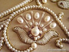 an elaborately designed brooch with pearls