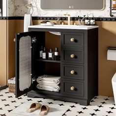 a bathroom with a sink, mirror and black cabinet in the middle of the floor