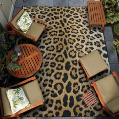 an animal print area rug with chairs and tables on it in the middle of a patio