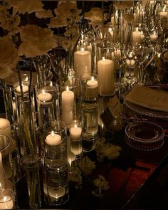 a table topped with lots of candles and flowers